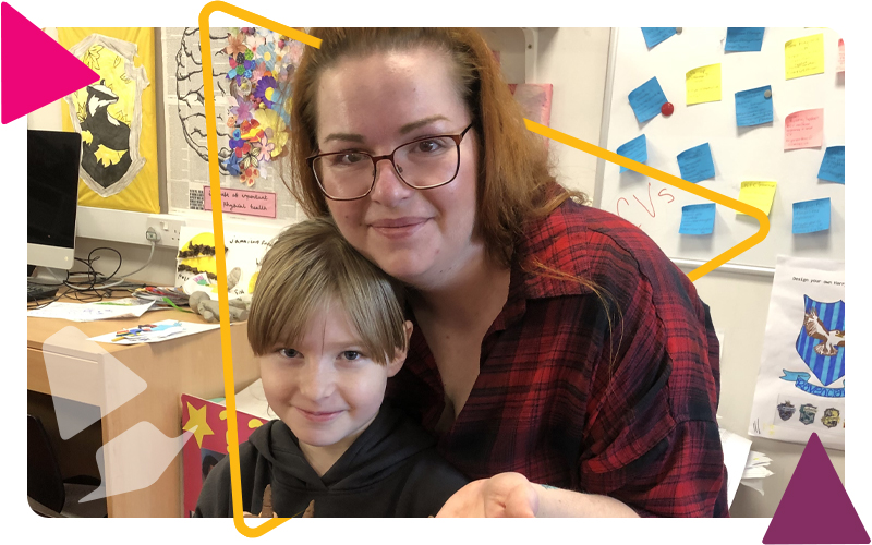 A woman and girl sitting smiling in the art room